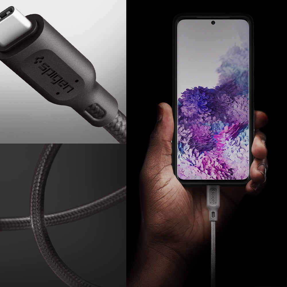 000CA25704 - DuraSync™ USB-C to USB-C 2.0 Cable C11C1 in Gunmetal showing the a hand holder a device while attached to a charger, a head of a charger and it's durable wire