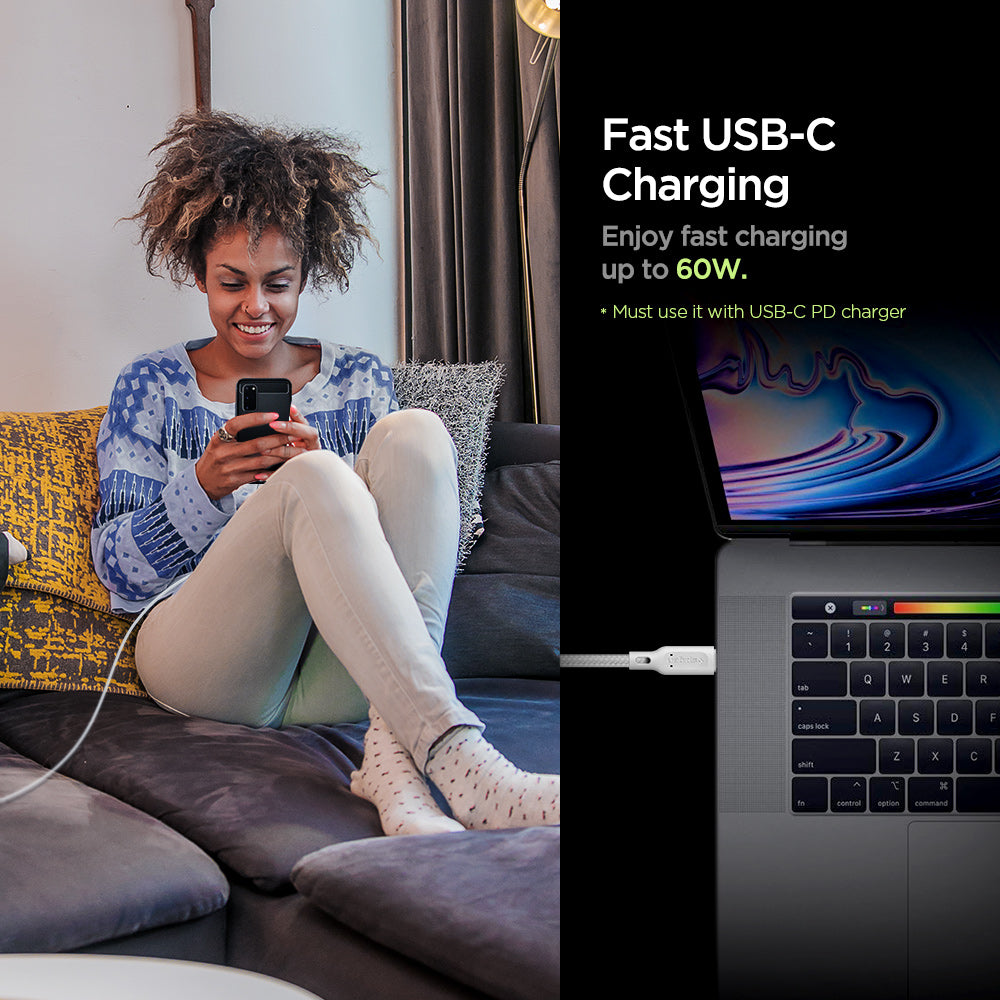 000CA25703 - DuraSync™ USB-C to USB-C 2.0 Cable C11C1 in White showing the Fast USB-C Charging. Enjoy fast charging up to 60W. (Must use it with USB-C PD charger). A woman sitting while holding a device attached to a long wired charger and another device attached to a cable charger