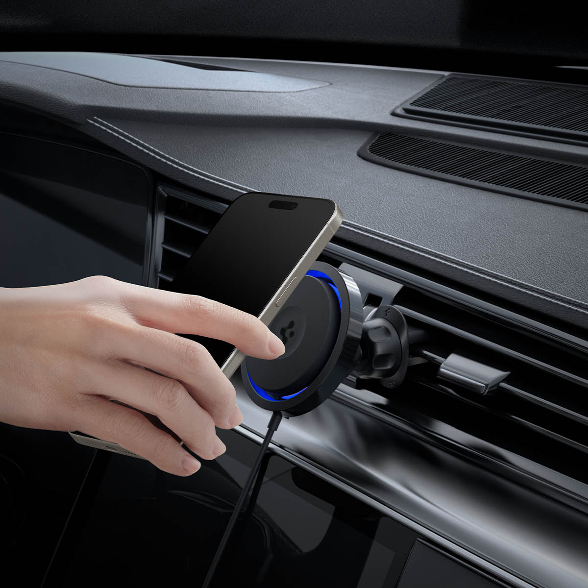 ACP07082 - OneTap Pro 3 CryoMax™ Air Vent Car Mount ITS12WC (MagFit) in Black showing a hand holding the device positioning in front of a car mount wireless charger