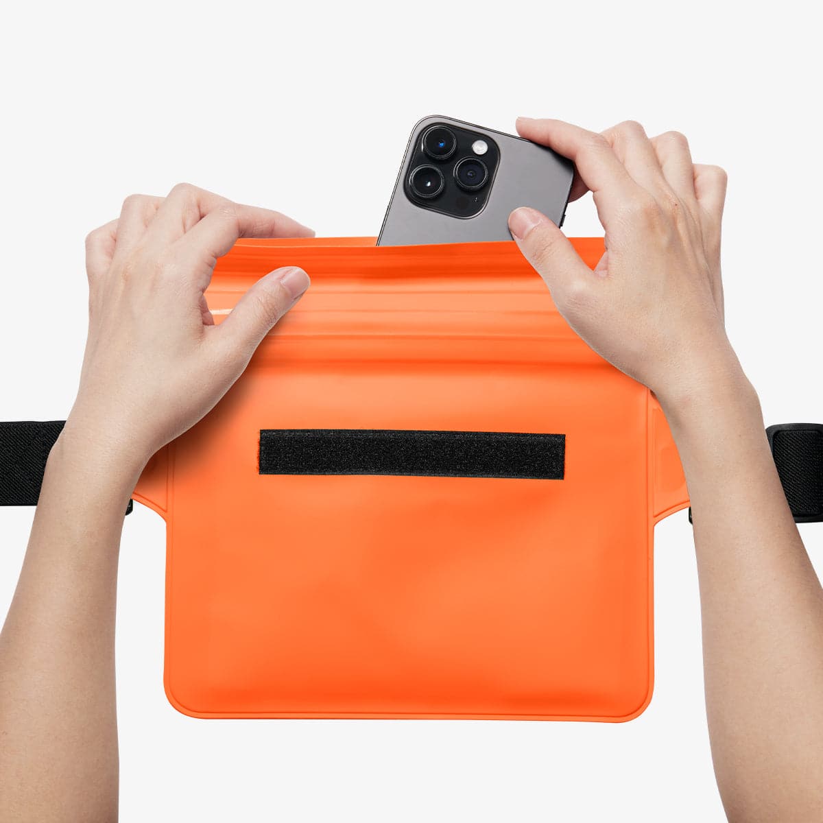 AMP06021 - AquaShield Waterproof Waist Bag (2 Pack) A620 in Sunset Orange showing the front, inserting a device inside the bag