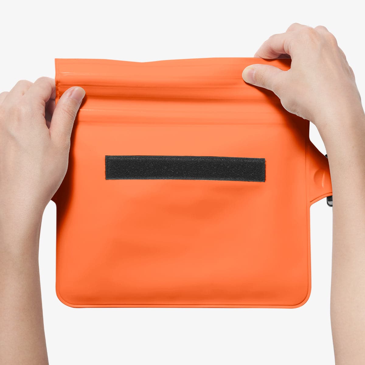 AMP06021 - AquaShield Waterproof Waist Bag (2 Pack) A620 in Sunset Orange showing the first step in sealing the bag with its zip lock