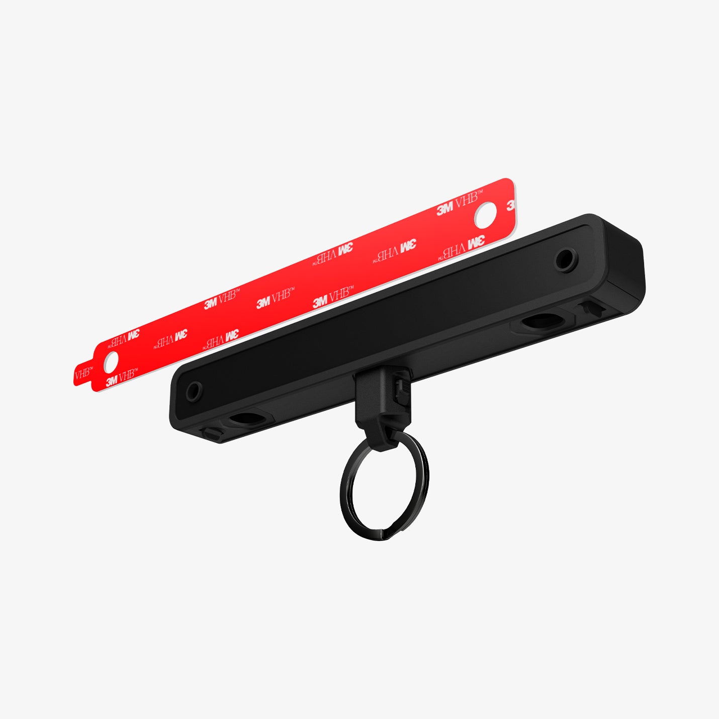 AHP06847 - Carabiner (Magnetic Keychain) Holder Hub in Black showing the double sided tape hovering in front of the magnetic keyholder hub with circular keyring attached