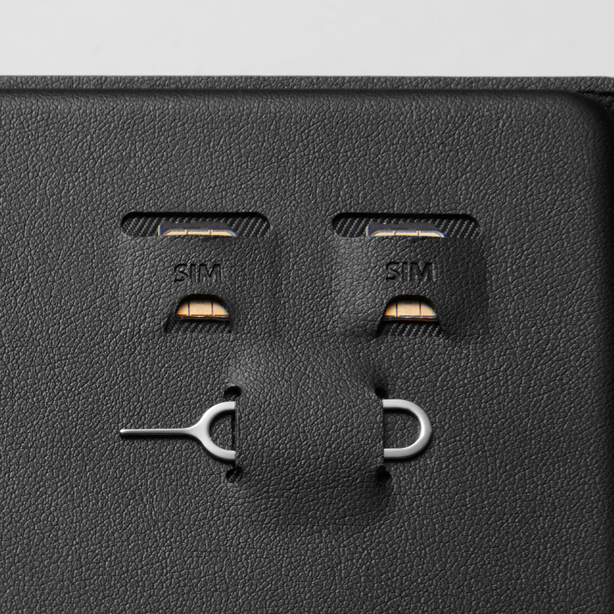 AFA05538 - Passport Holder in black showing the sim slots for sim cards and a pin ejector