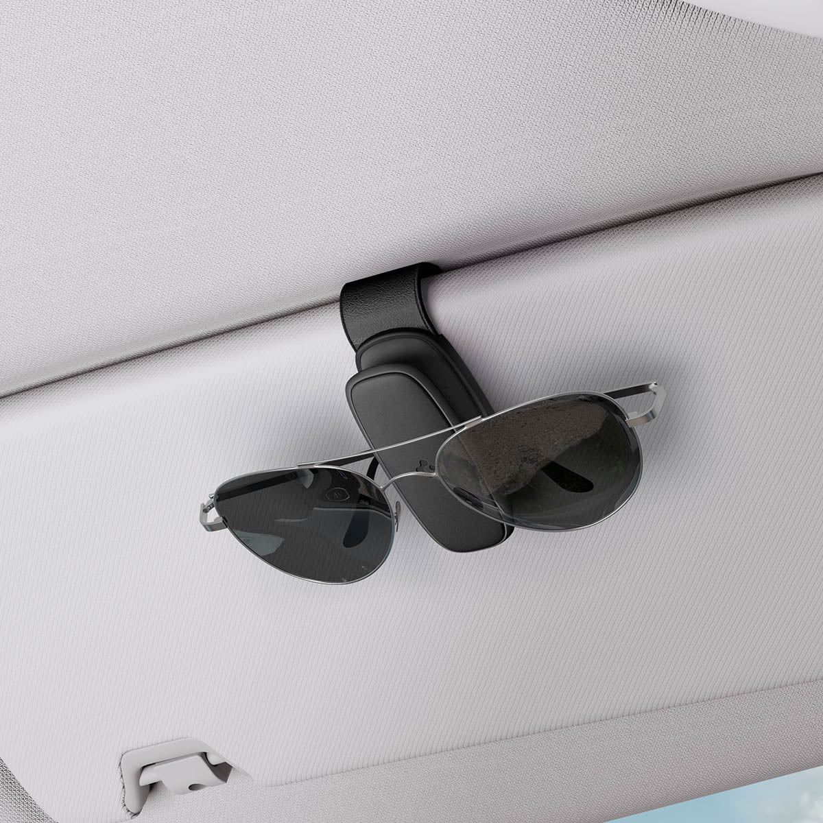 ACP08824 - Visor Sunglass Holder SH100 in Black showing the holder attached to a car visor with sunglasses attached to it