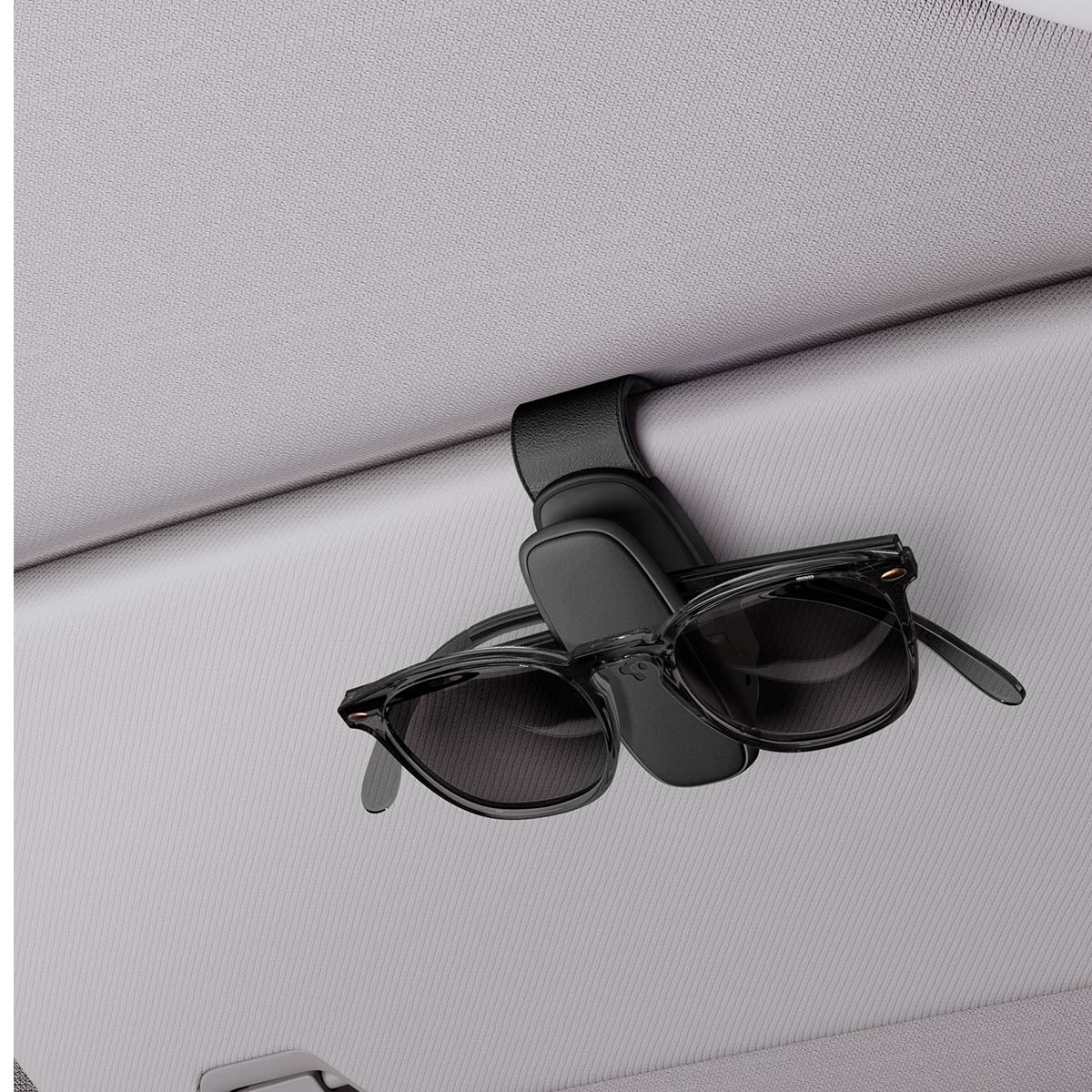 ACP08824 - Visor Sunglass Holder SH100 in Black showing the holder attached to a car visor with sunglasses attached to it