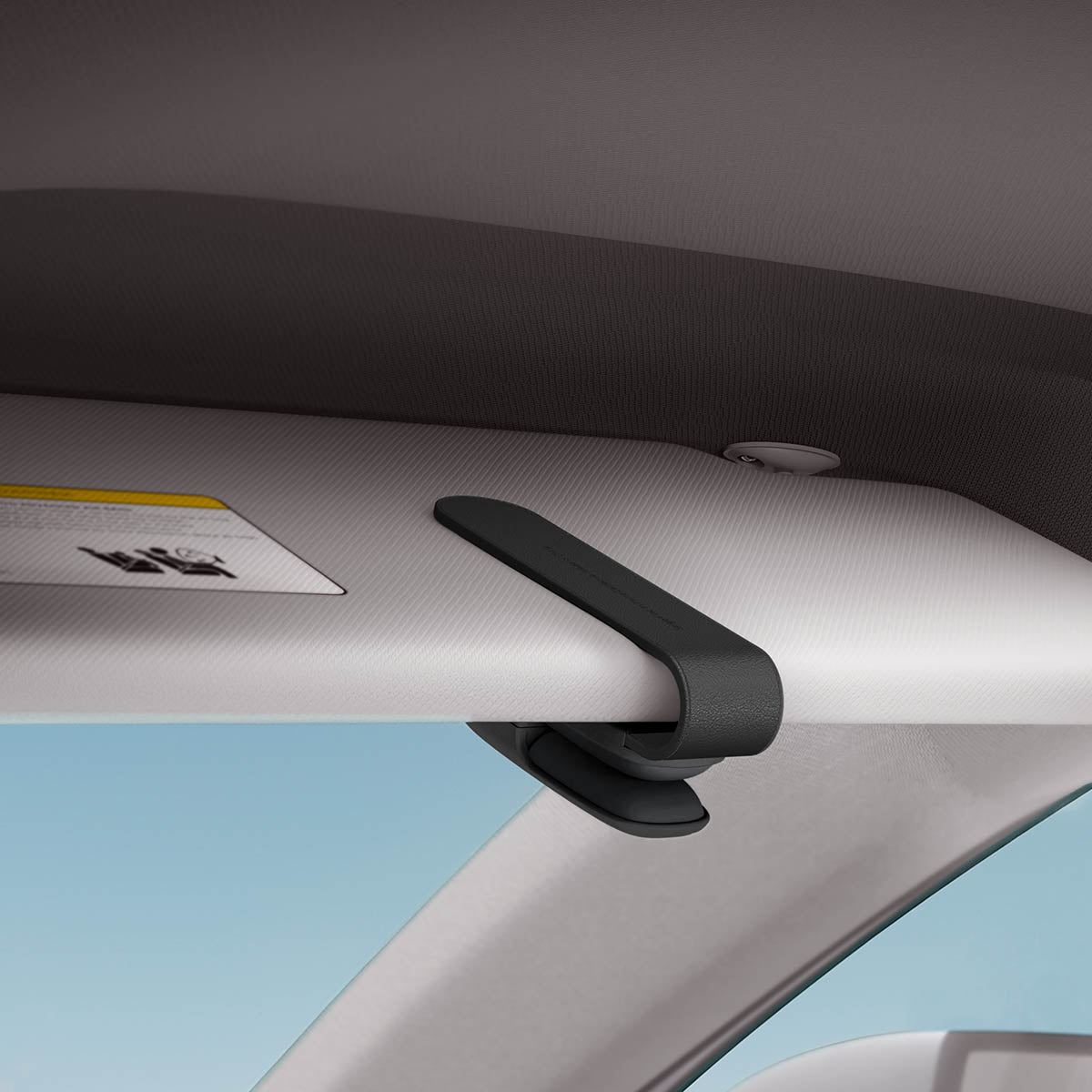 ACP08824 - Visor Sunglass Holder SH100 in Black showing the holder attached to a car visor