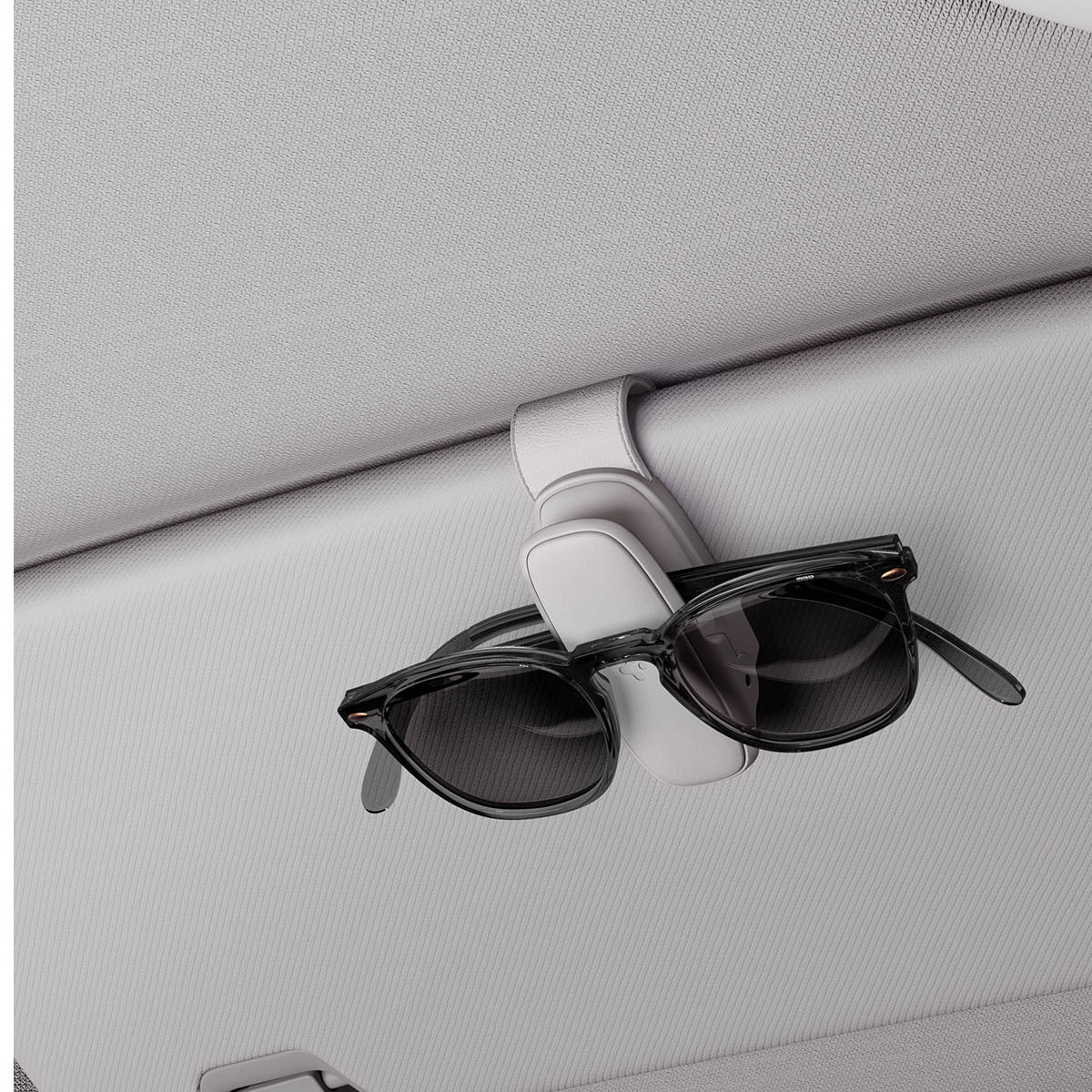 ACP08825 - Visor Sunglass Holder SH100 in Gray showing the holder attached to a car visor with sunglasses attached to it