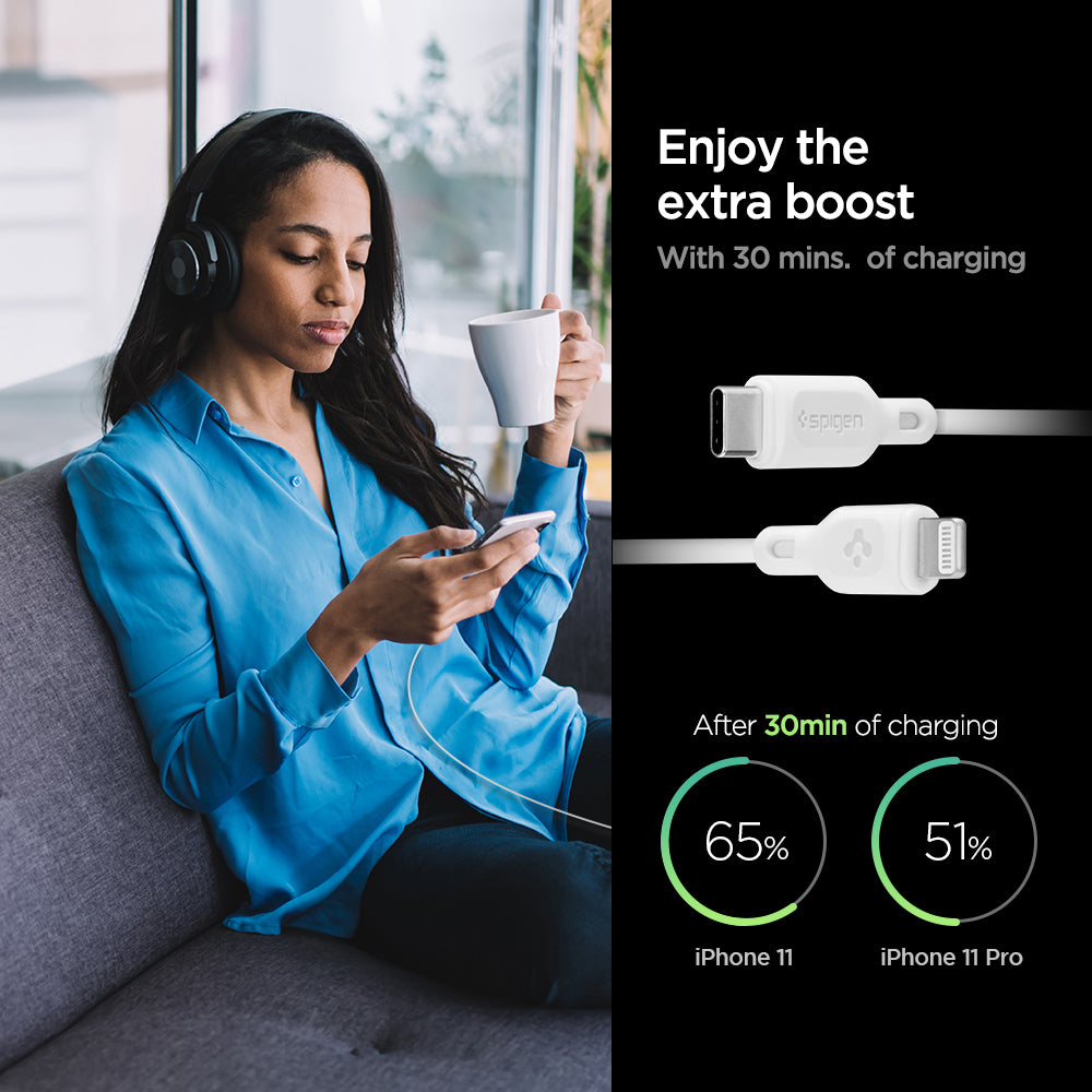 000CA26356 - DuraSync™ USB-C to Lightning Cable C10CL in White showing the Enjoy the extra boost. With 30 mins. of charging. After 30 mins of charging, iPhone 11 (65%) and iPhone 11 Pro (51%). also showing 2 cable heads and a woman sitting holding a mug and a device in another hand