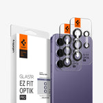 AGL07443 - Galaxy S24 Optik Pro EZ Fit Lens Protector in Violet showing the camera lens protector hovering above another lens protector tray and device showing back, behind it, is the packaging