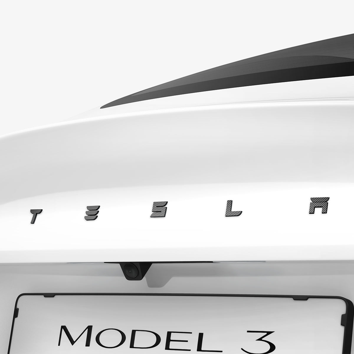 ACP08550 - Tesla Model 3 Highland Rear Emblem Logo Cover TO322H in Carbon showing the front partial side